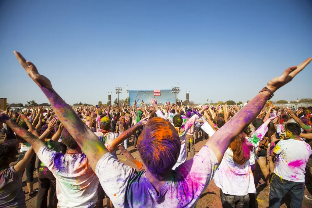 A crowd of people with their arms in the air